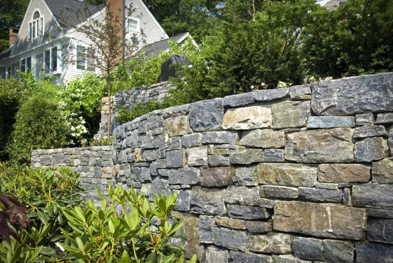 Natural stone retaining wall completed by Rosales